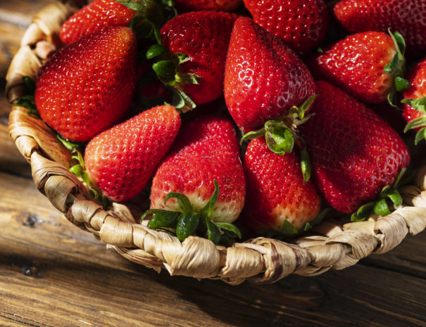Fresh strawberry with a strong summer light, selective focus image